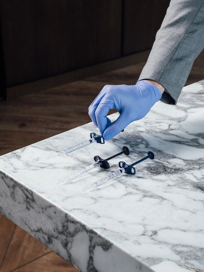 Person using electric polisher to restore and polish white marble countertop surface - Hand rejuvenation in Chevy Chase, MD